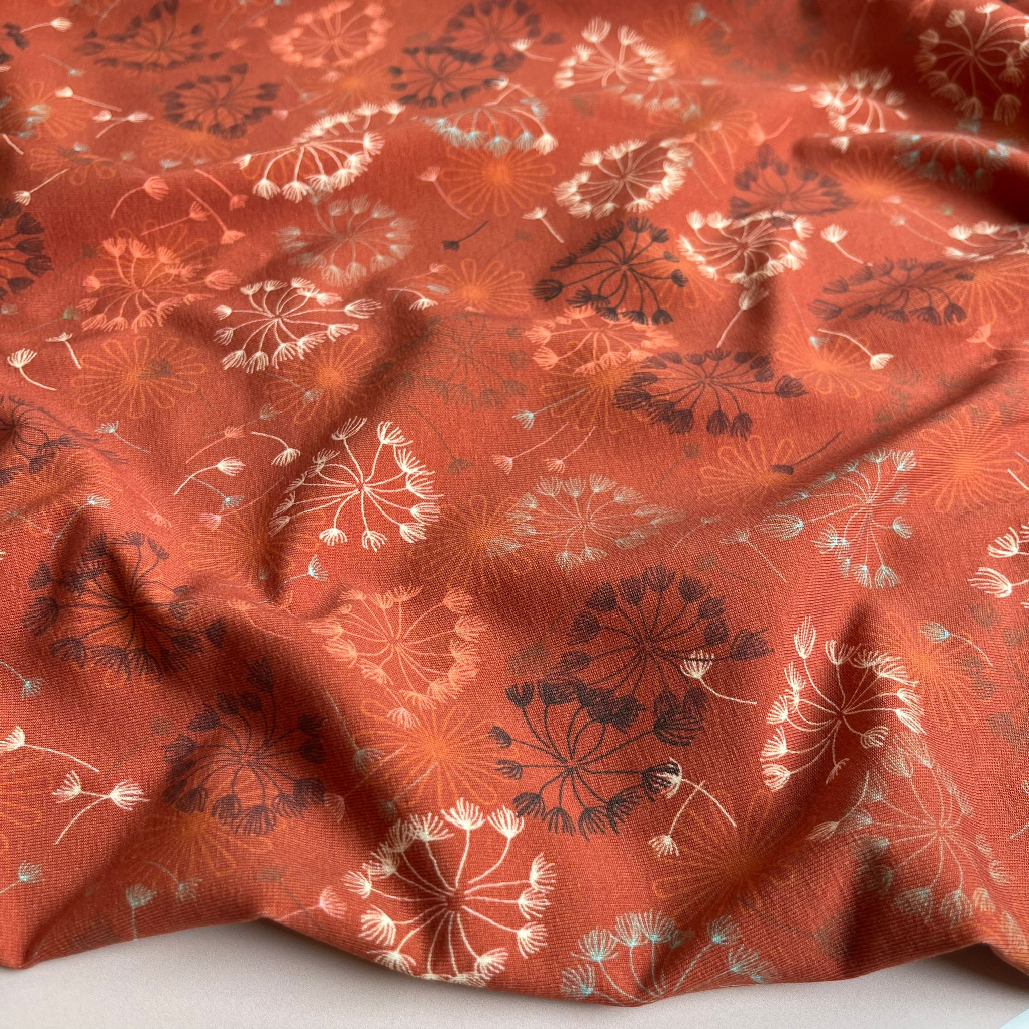 Danish Design - Dandelion on Rust Cotton Jersey Fabric