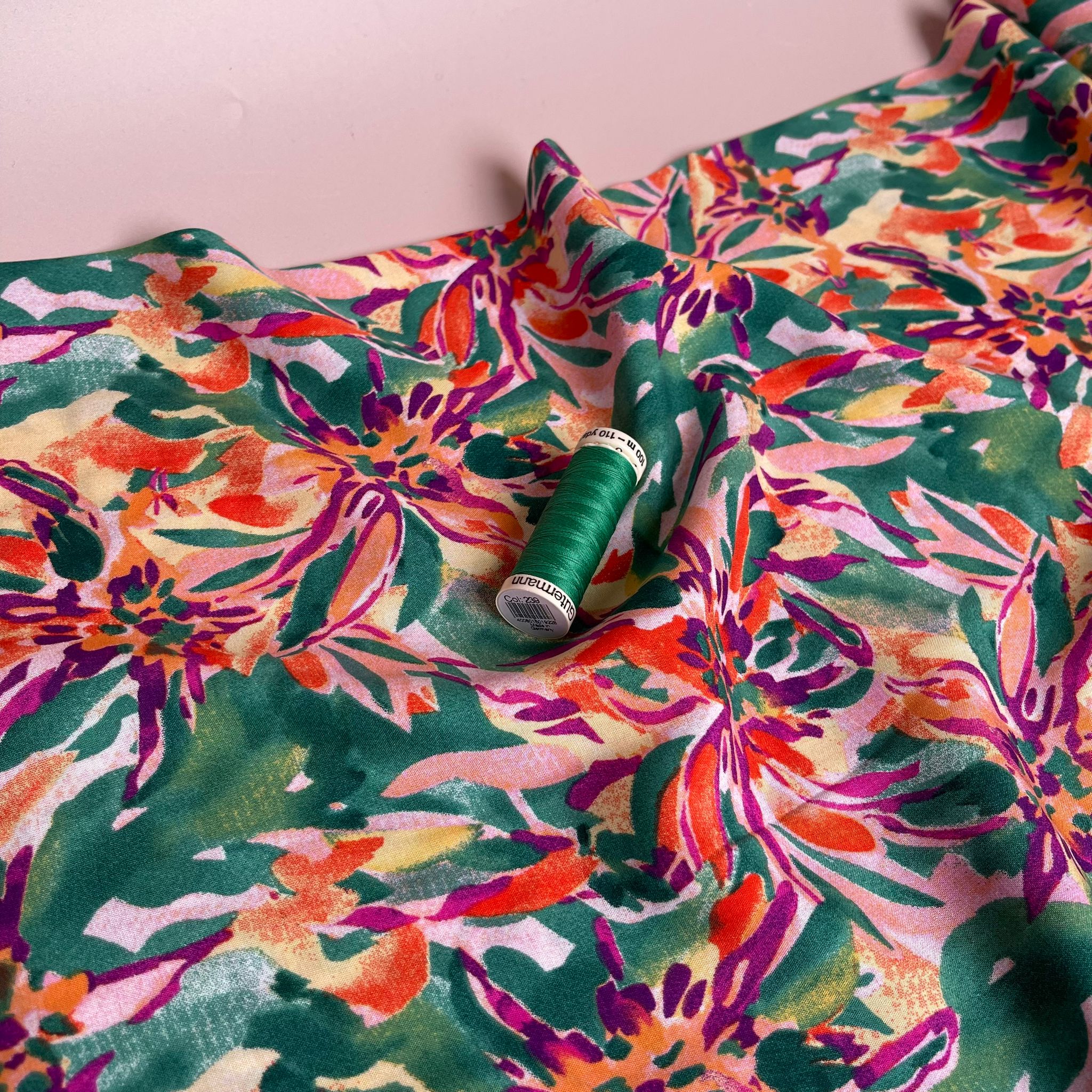 Vibrant Blooms on Green Viscose Fabric