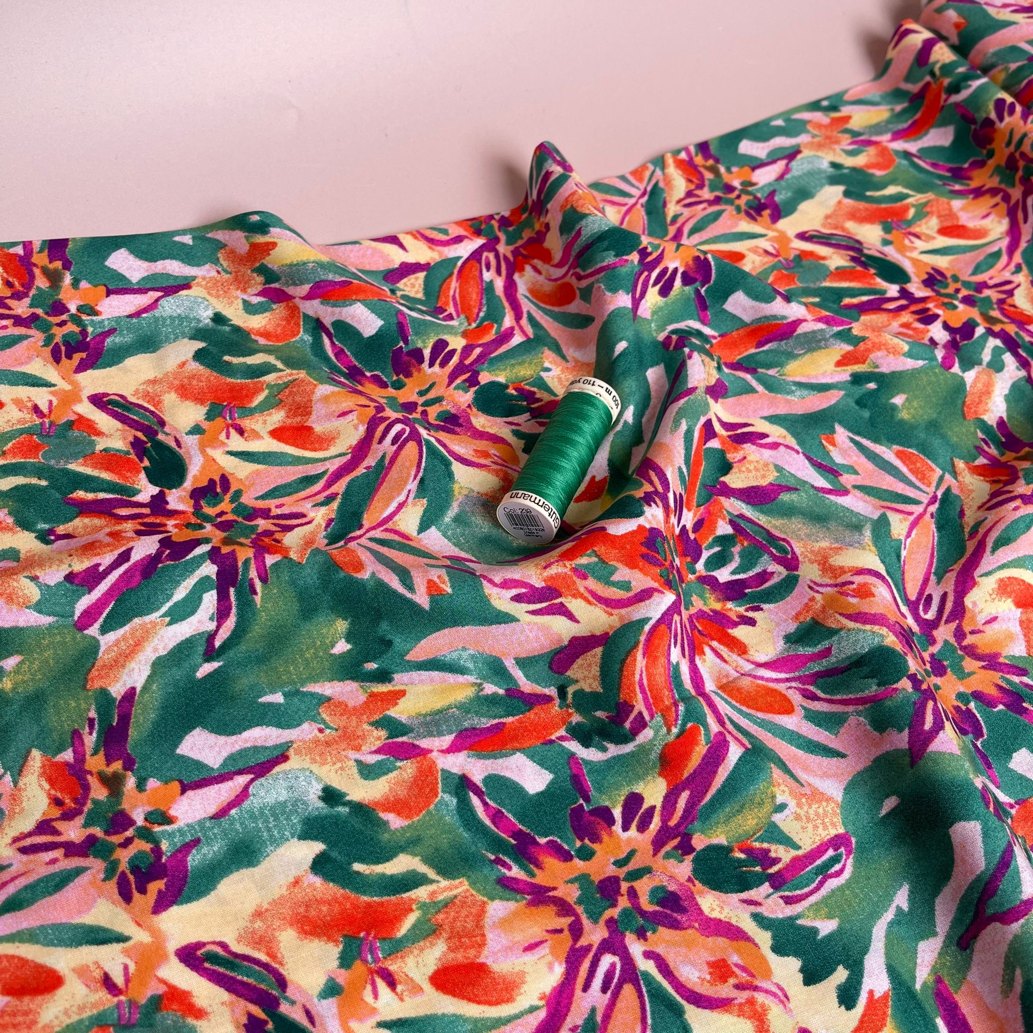 Vibrant Blooms on Green Viscose Fabric