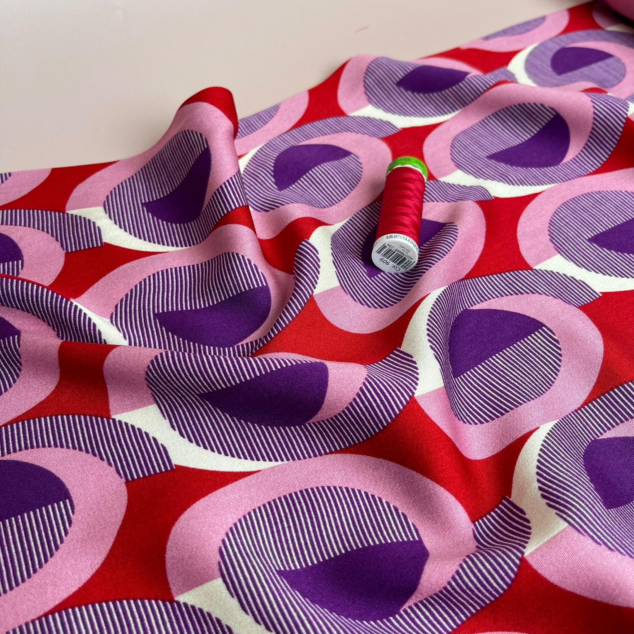 REMNANT 0.55 Metre - Abstract Circles on Red Viscose Twill Sateen Fabric