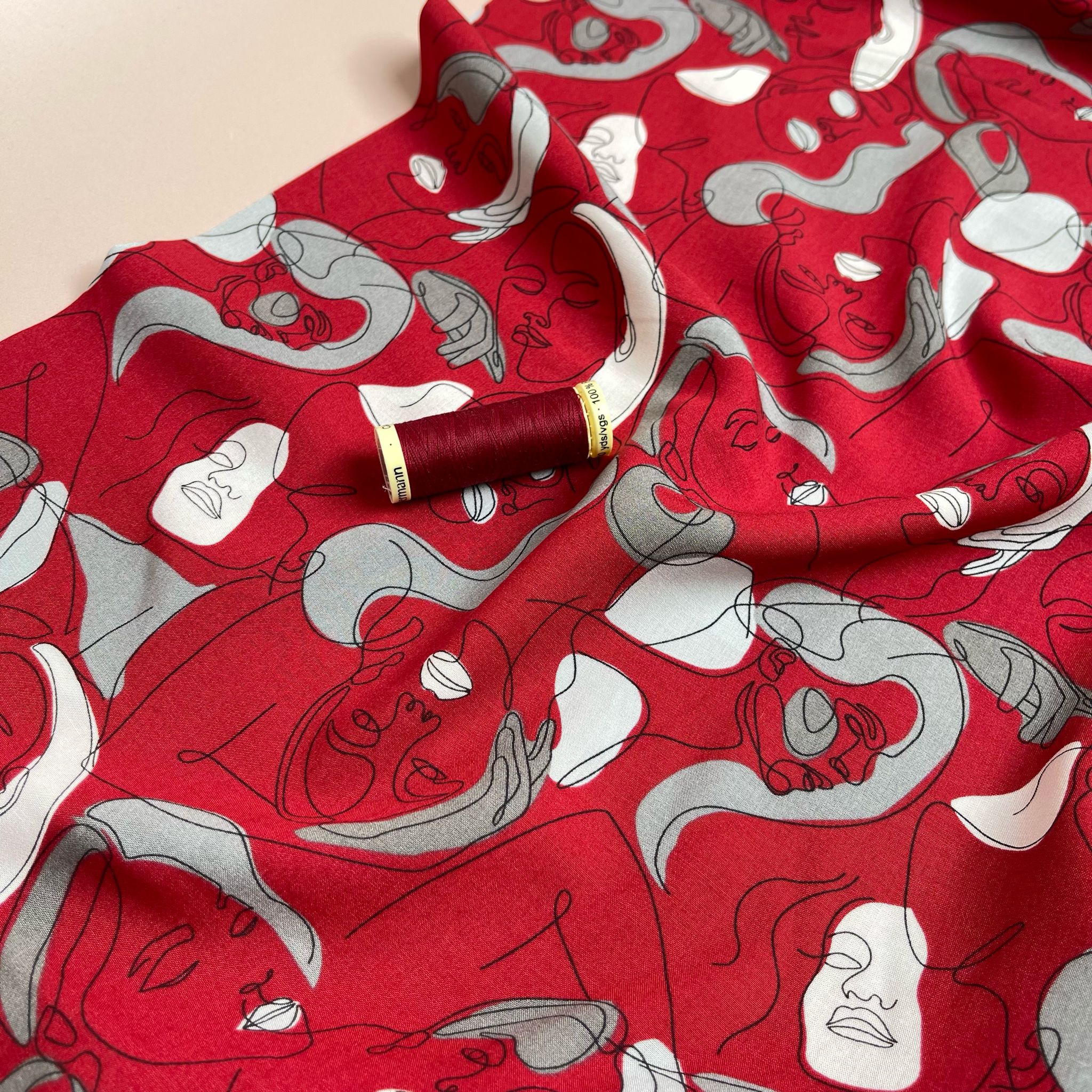 Faces on Red Viscose Fabric