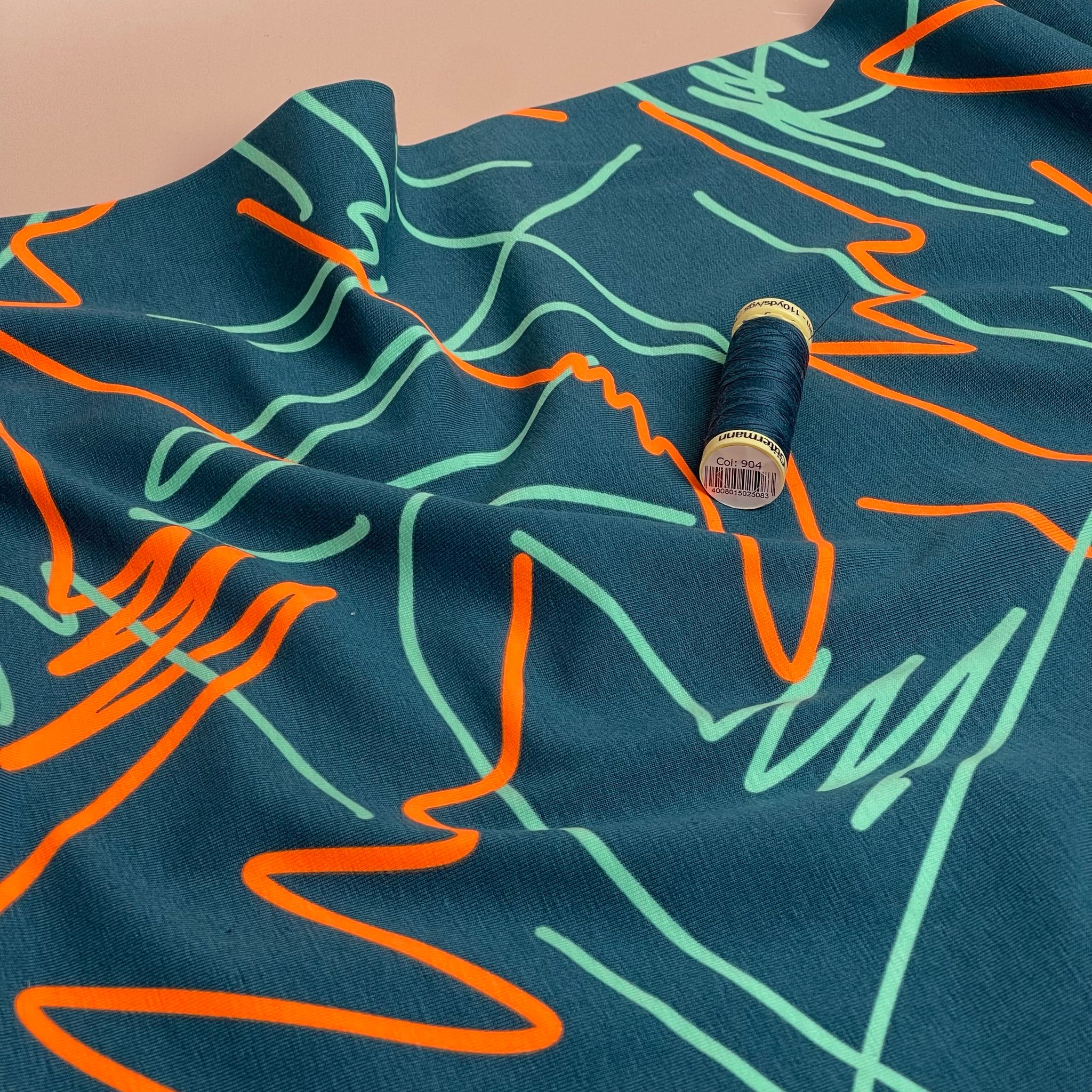 Neon Doodles on Dark Teal Cotton Jersey Fabric