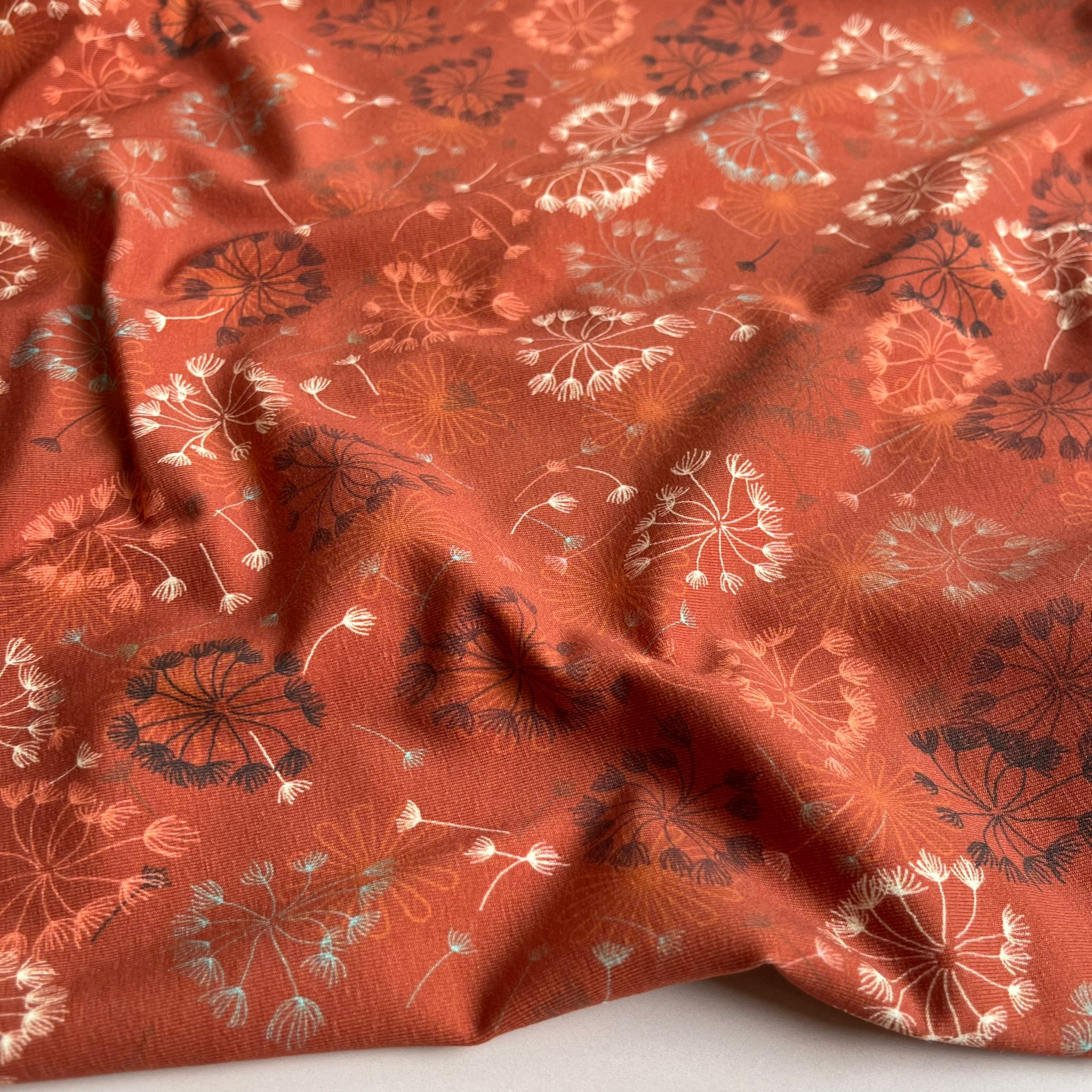 Danish Design - Dandelion on Rust Cotton Jersey Fabric