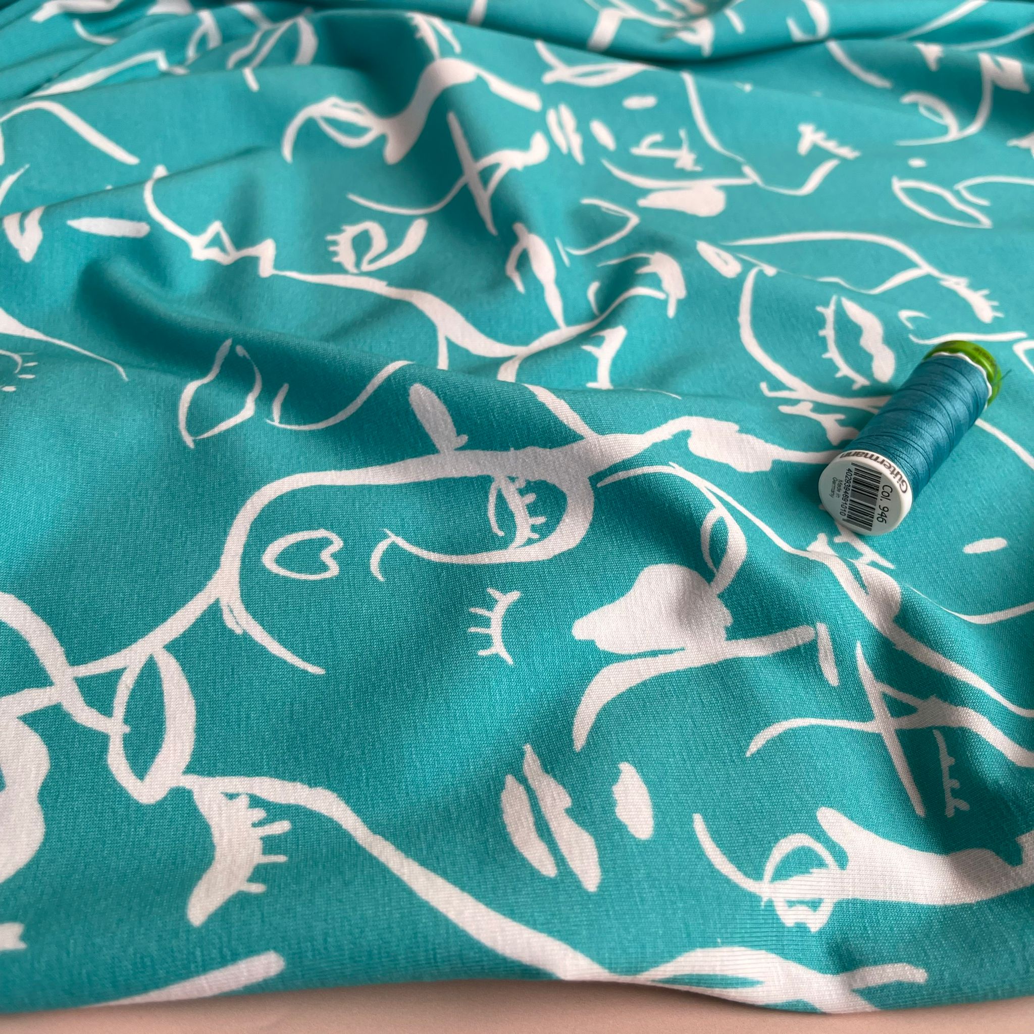 REMNANT 2.33 Metres - Danish Design - Painted Faces on Turquoise Cotton Jersey Fabric