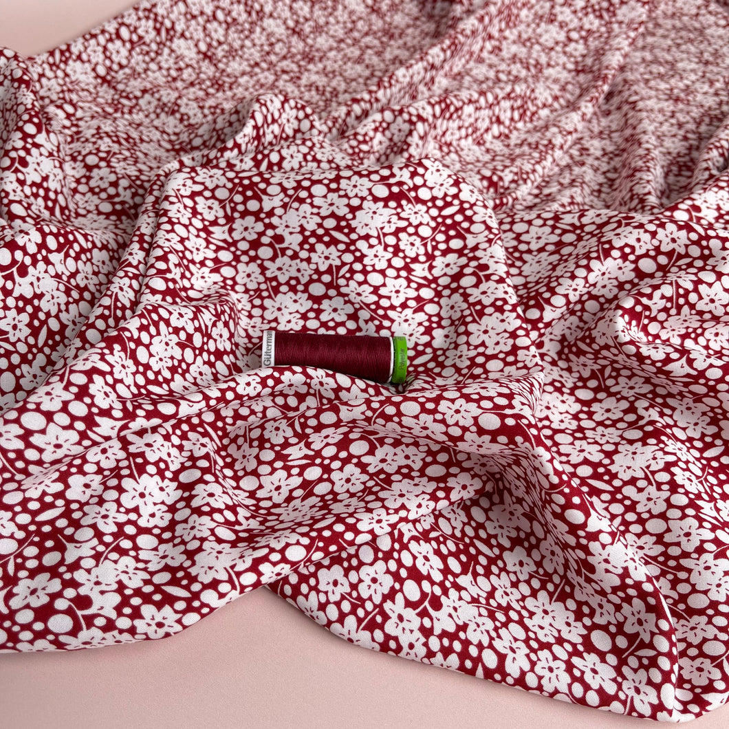 White Floral Field on Red Viscose Fabric